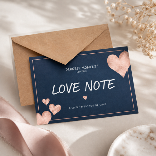 Navy card with 'Love Note' text and rose gold hearts, accompanied by a brown envelope on a light background.